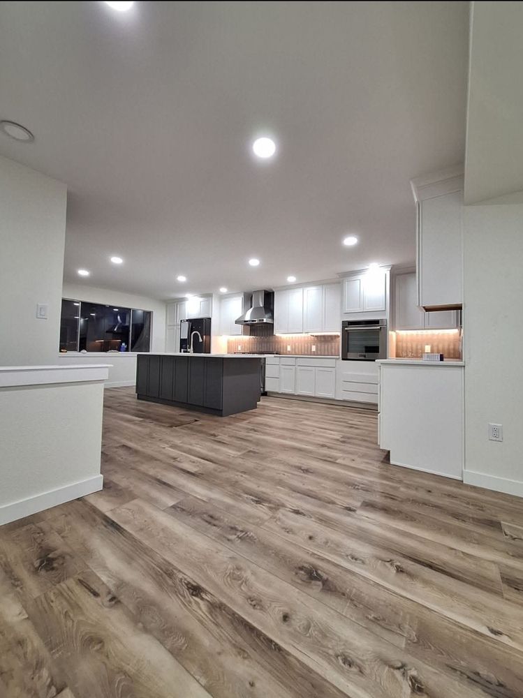 o (2) A remodeled kitchen with light oak floors, recessed lights, and granite countertops