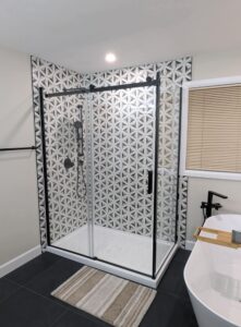 Mosaic tiled shower with full glass door